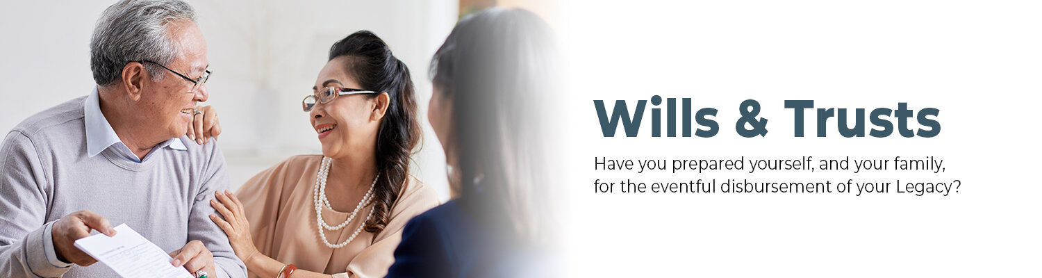 An older couple smiling and holding documents while speaking with a professional in an office setting. Text reads "Wills & Trusts – Have you prepared yourself, and your family, for the eventful disbursement of your Legacy?"