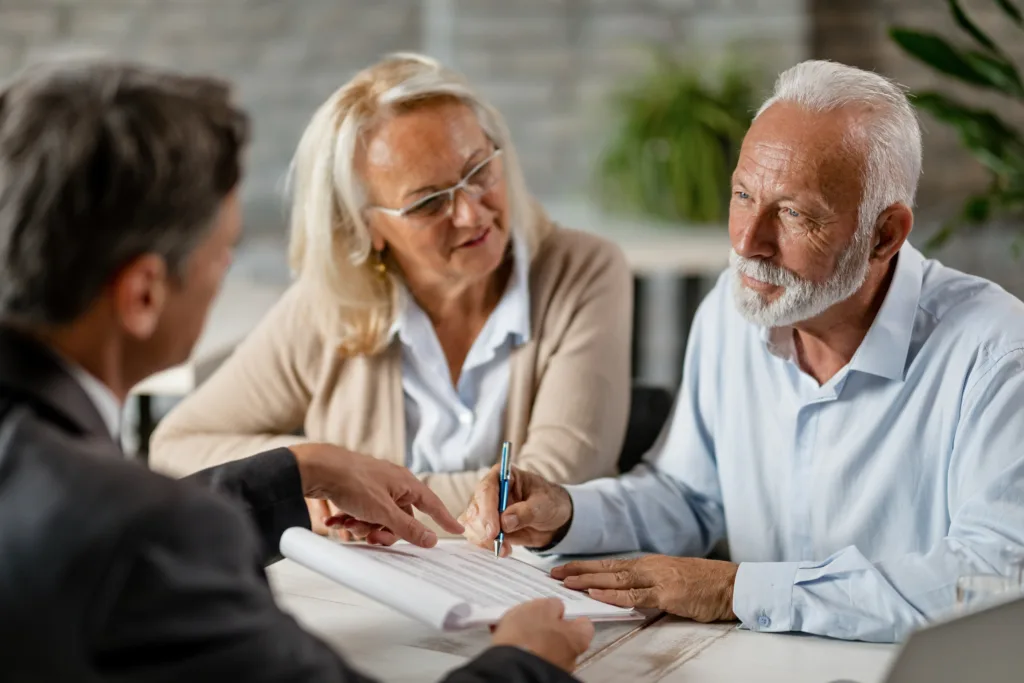 Sitting at a desk, the Probate attorney reviews paperwork with their client. 