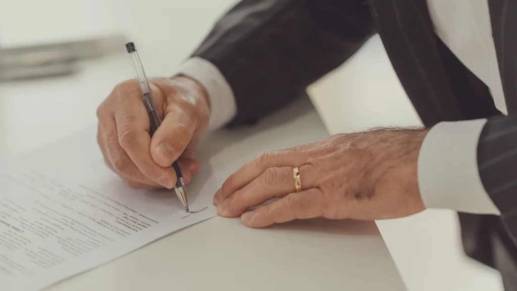 Lawyer reviewing legal documents before signing while handling a will contest case in California.