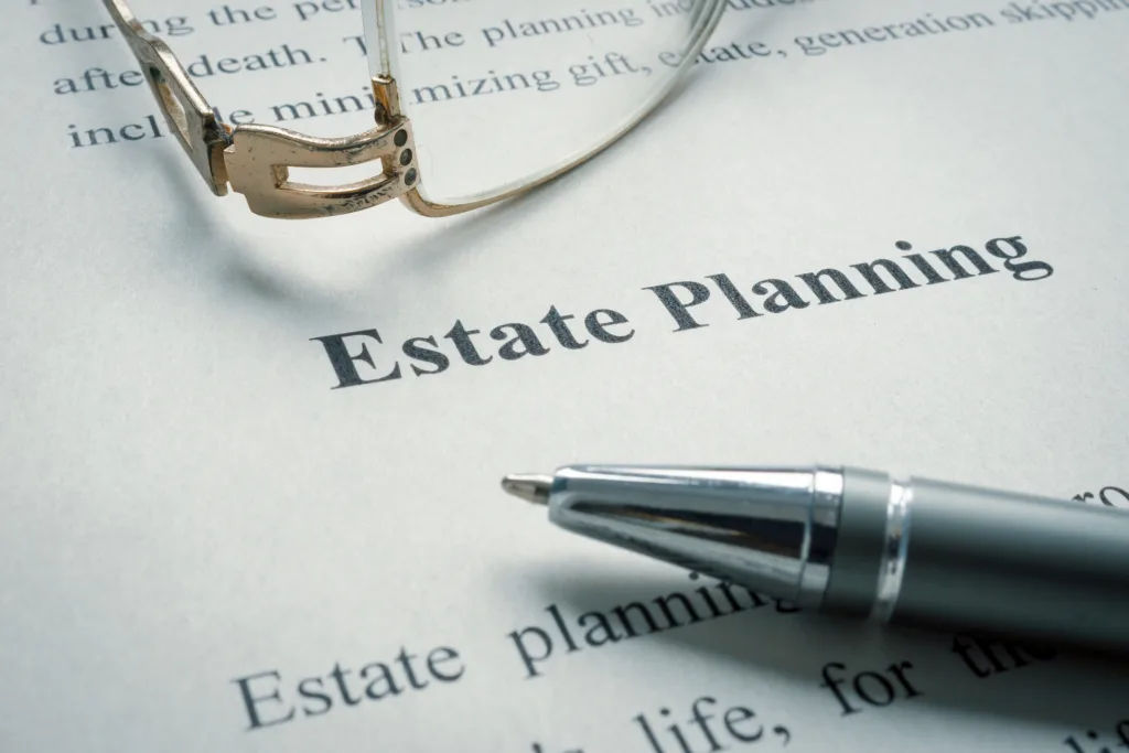 Close-up of estate planning document with glasses and pen on a desk.

