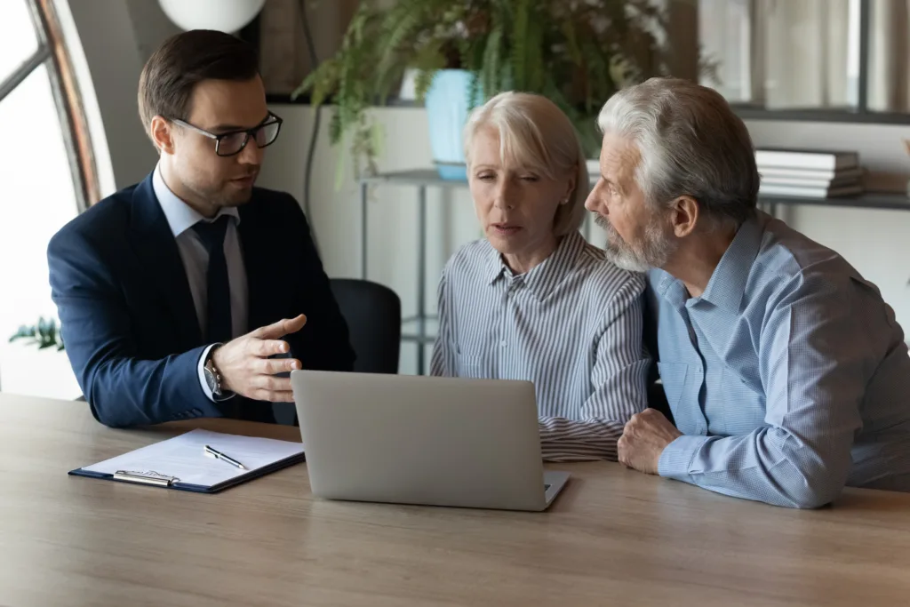 Lawyer advising an older couple during an estate planning consultation.