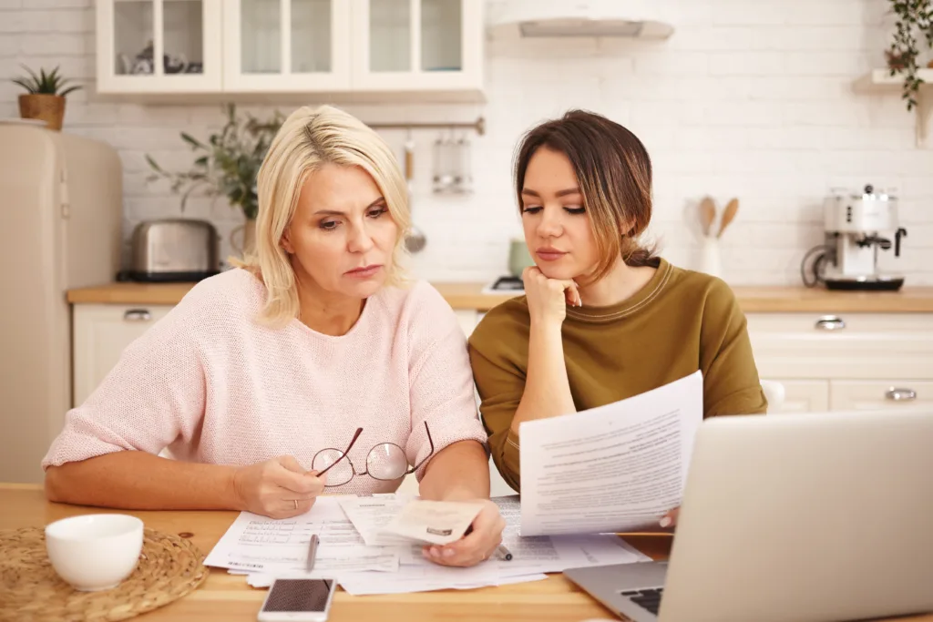 Woman reviewing will documents with family member, illustrating the process of evaluating a no-contest clause in California