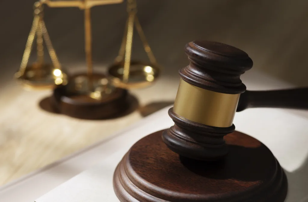 Top-down view of legal documents and judge's items representing no-contest clause enforcement in California wills